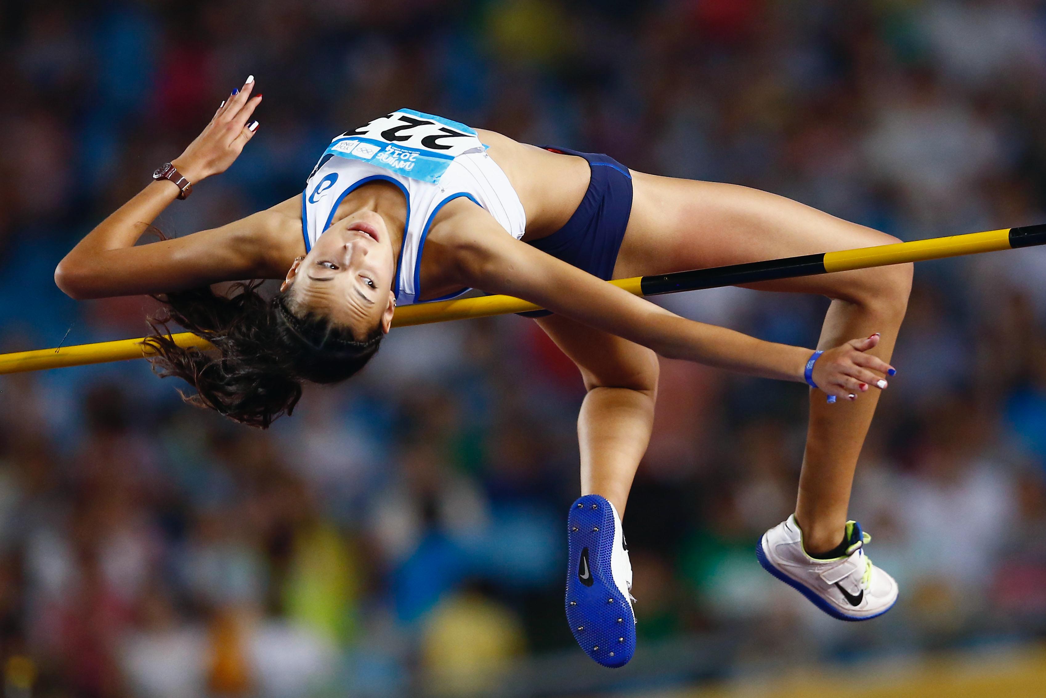 Athlete in the air passing the bar in a high jump competition.