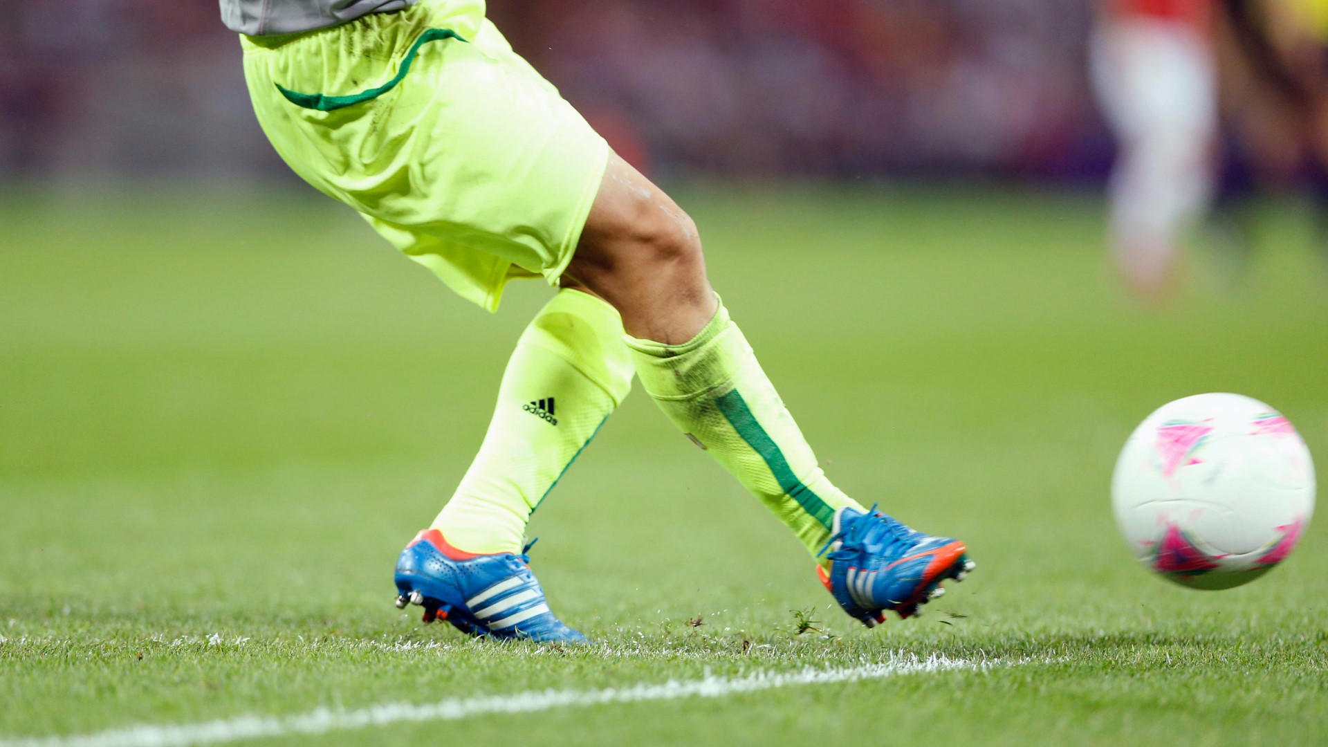 Football player on the field, who have just kicked the ball with his right leg.