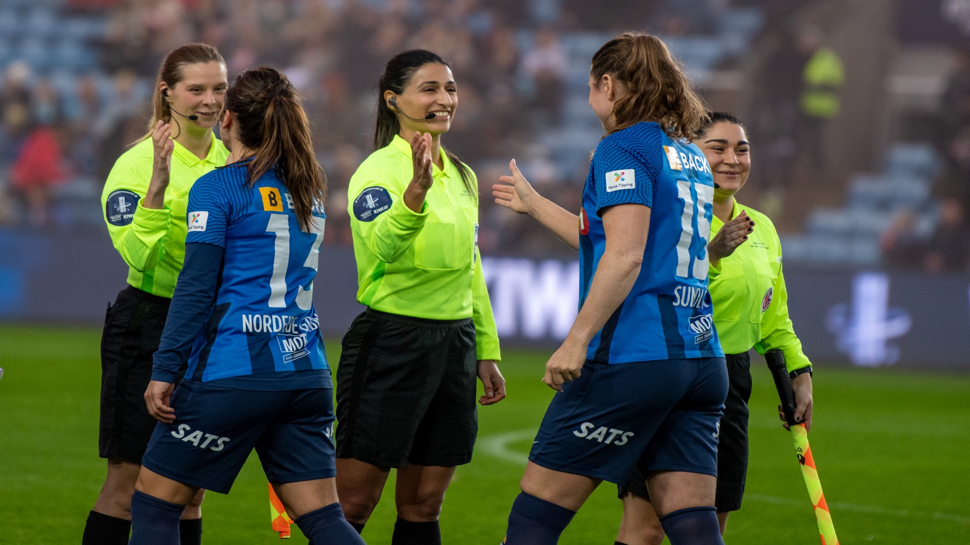 Footballers and referees shaking hands before a football match.