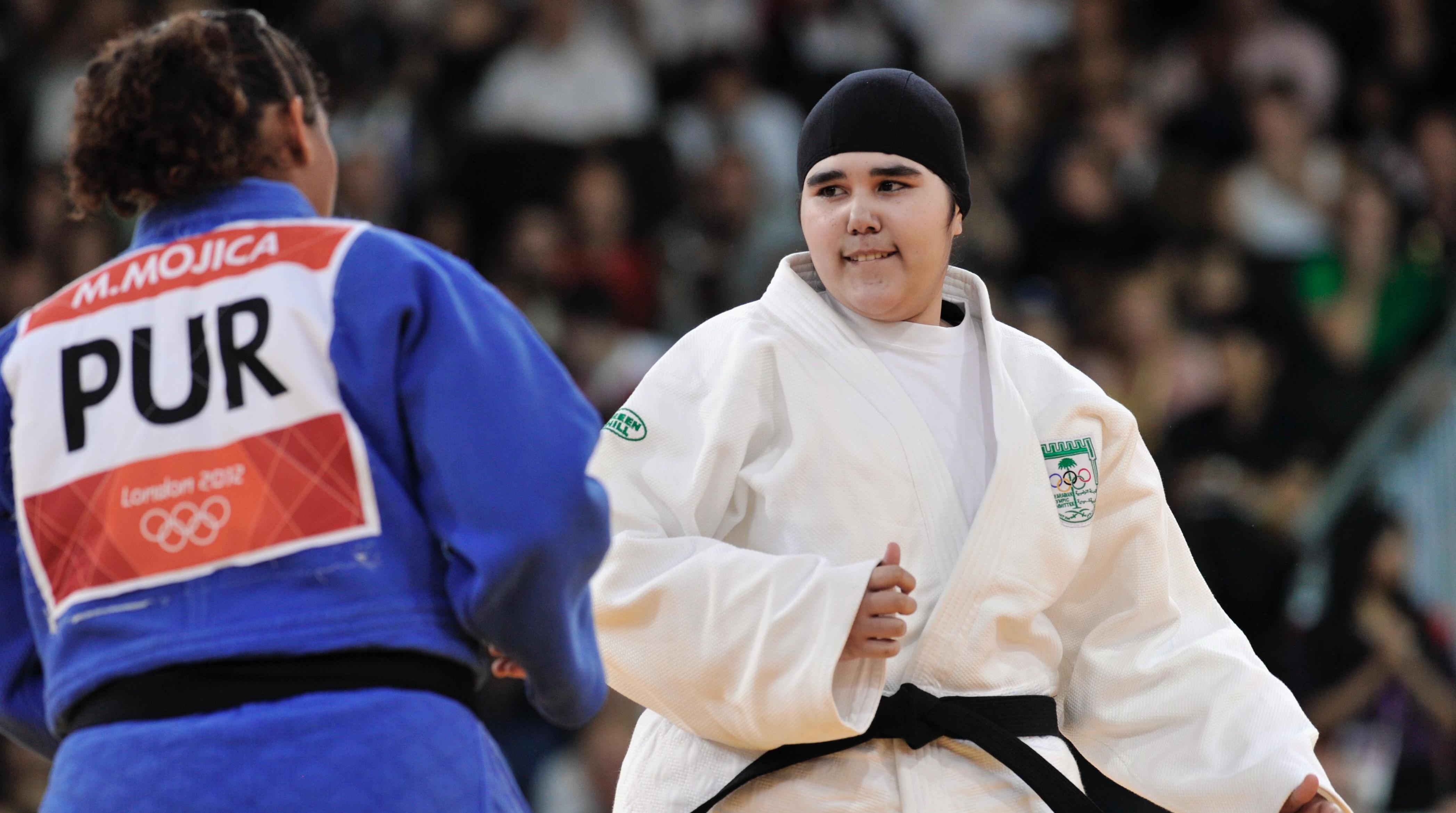 Two Judo athletes in a competition getting ready to fight each other.