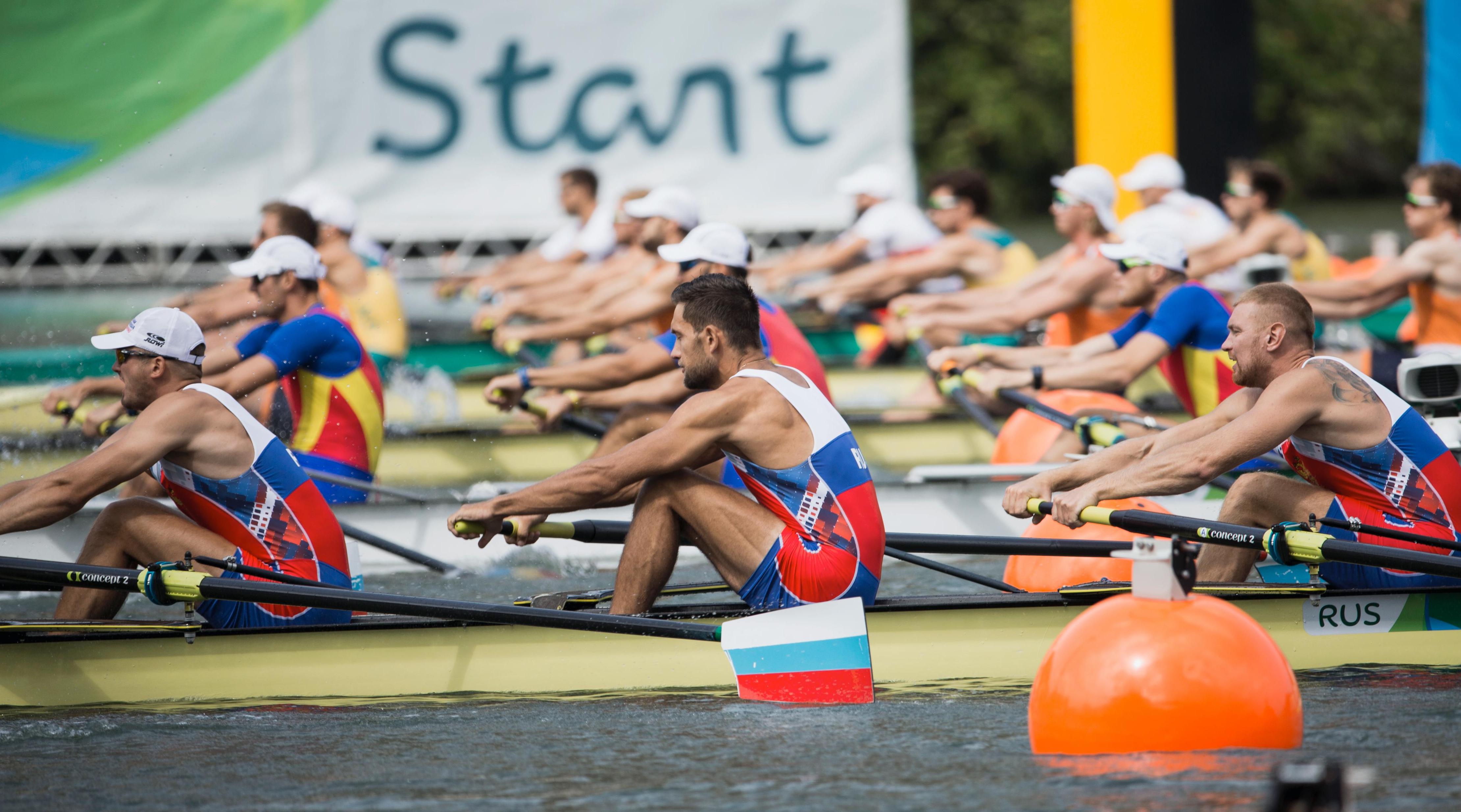 Several rowers in several different boats during a race.