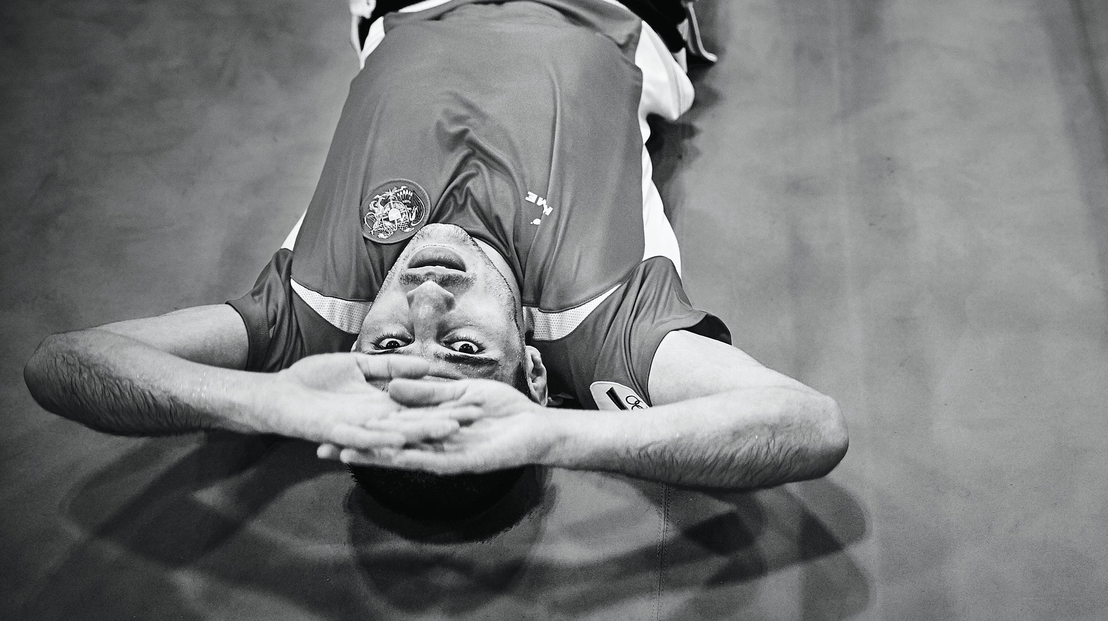 Athlete laying on the ground and looking up.