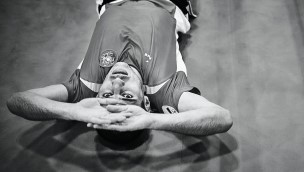 Athlete laying on the ground and looking up.